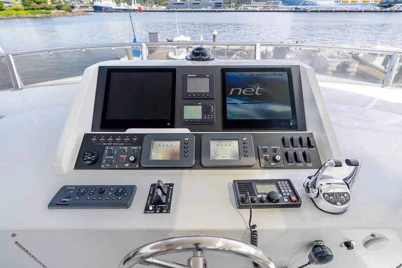 Whitefish Yacht Photos Pics Pilothouse controls of 2013 Ocean Alexander 72, featuring navigation screens and communication equipment.