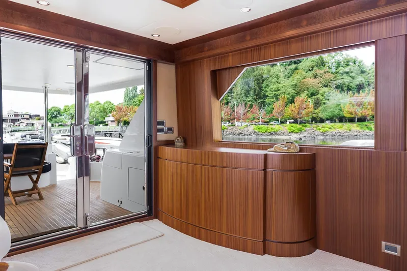 Whitefish Yacht Photos Pics Luxurious interior of 2013 Ocean Alexander 72 Pilothouse yacht with wood paneling and large window.