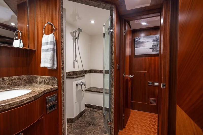 Whitefish Yacht Photos Pics Luxurious bathroom in 2013 Ocean Alexander 72 Pilothouse yacht with marble accents and wood paneling.
