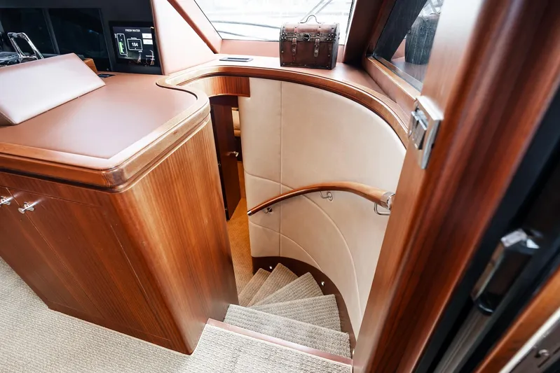 Whitefish Yacht Photos Pics Luxurious interior staircase of 2013 Ocean Alexander 72 Pilothouse yacht, featuring elegant wood finish.