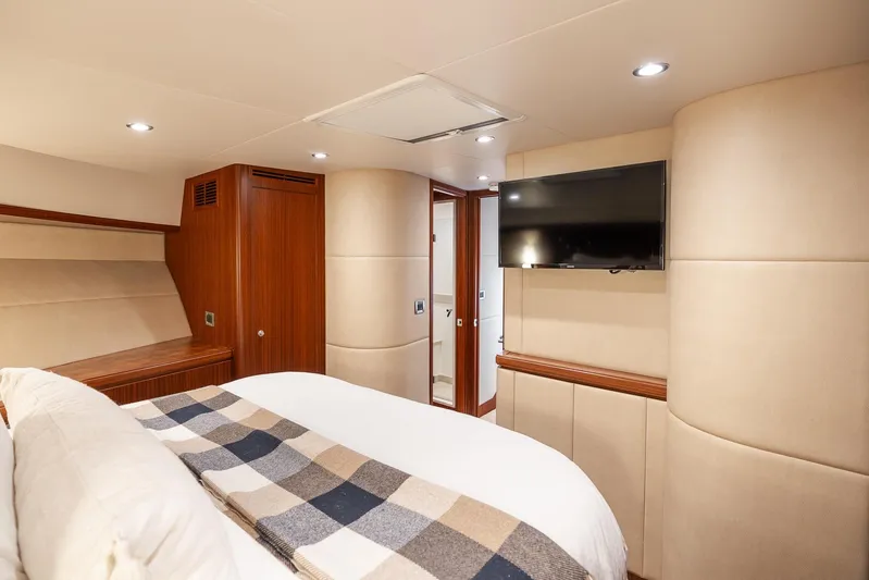 Whitefish Yacht Photos Pics Luxurious bedroom interior of 2013 Ocean Alexander 72 Pilothouse yacht with TV and elegant decor.