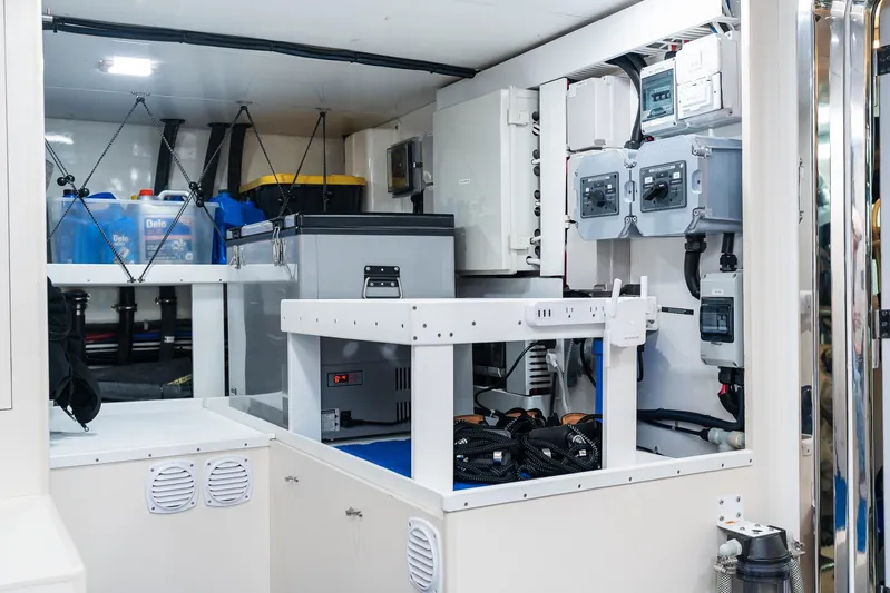 Whitefish Yacht Photos Pics Engine room of 2013 Ocean Alexander 72 Pilothouse yacht, featuring equipment and storage.