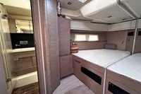 Luxurious interior of 2017 Hanse 548 yacht featuring a cozy bedroom and modern bathroom.