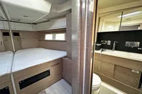 Luxurious interior of 2017 Hanse 548 yacht featuring bedroom and modern bathroom.