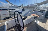 2017 Hanse 548 yacht cockpit with steering wheel and wooden deck, docked at marina.