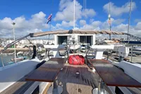 Deck view of 2017 Hanse 548 yacht with dual steering wheels and wooden seating.