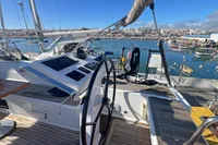 Helm of 2017 Hanse 548 yacht with marina view, featuring modern navigation controls.