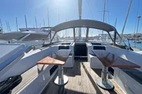 2017 Hanse 548 yacht cockpit with twin tables, docked in a sunny marina.