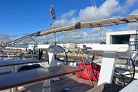 Deck view of a 2017 Hanse 548 yacht in a marina under a clear blue sky.