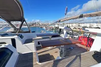 Hanse 548 yacht deck, 2017 model, featuring seating and table, docked in a marina.