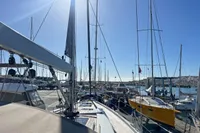 Sailboats docked at a marina under clear blue skies, featuring a 2017 Hanse 548 yacht.