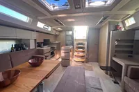 Luxurious interior of 2017 Hanse 548 yacht with modern kitchen and dining area.