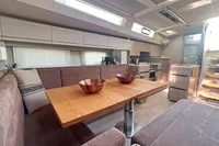 Luxurious interior of 2017 Hanse 548 yacht with modern dining area and stylish decor.
