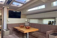Luxurious interior of 2017 Hanse 548 yacht with modern seating and dining area.