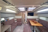 Luxurious interior of 2017 Hanse 548 yacht with modern seating and dining area.