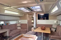 Luxurious interior of 2017 Hanse 548 yacht with modern seating and skylights.