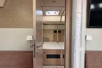 Interior of 2017 Hanse 548 yacht, featuring a cozy bedroom with modern wooden decor.