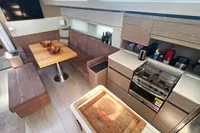 Modern interior of 2017 Hanse 548 yacht with kitchen and dining area.