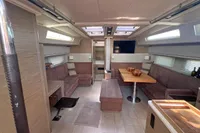 Spacious interior of 2017 Hanse 548 yacht with modern seating and dining area.