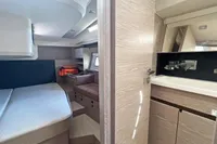 Interior of 2017 Hanse 548 yacht featuring bedroom and bathroom with modern wood finishes.