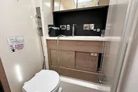 Bathroom interior of 2017 Hanse 548 yacht, featuring modern fixtures and wood accents.