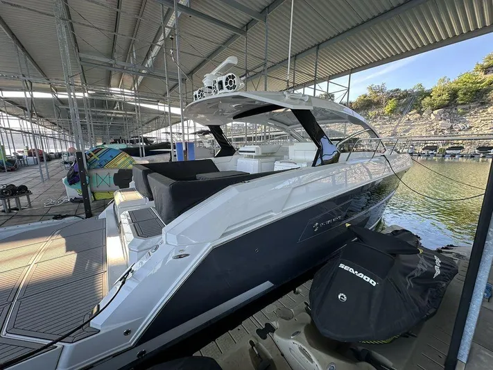 Yacht Photos Pics 2021 Cruisers Yachts 39 Express Coupe docked in a marina under a covered structure.