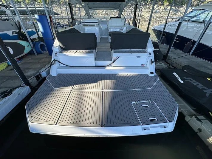  Yacht Photos Pics 2021 Cruisers Yachts 39 Express Coupe with spacious deck and seating in marina.