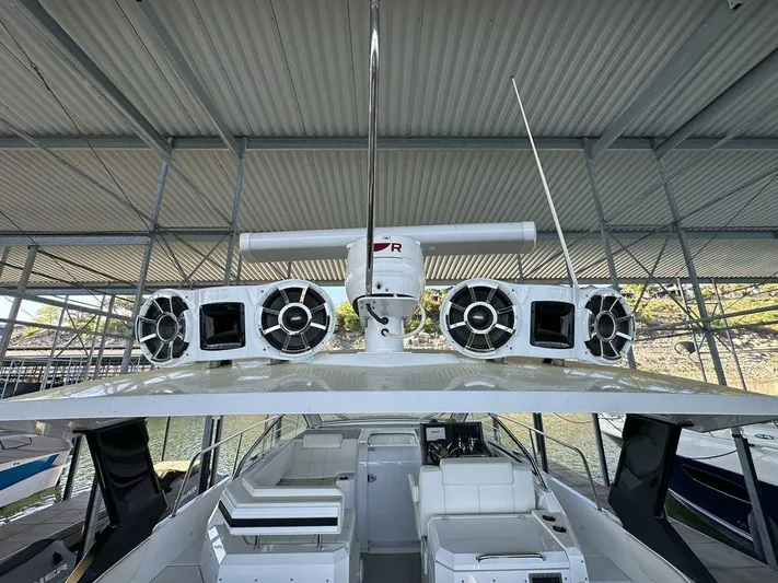  Yacht Photos Pics 2021 Cruisers Yachts 39 Express Coupe with advanced audio system under covered dock.