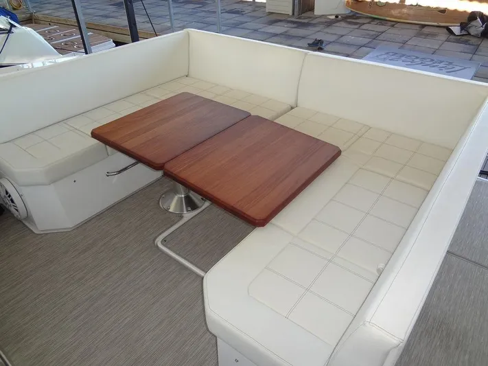  Yacht Photos Pics 2021 Cruisers Yachts 39 Express Coupe interior seating with wooden table.