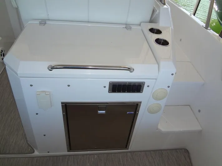  Yacht Photos Pics 2021 Cruisers Yachts 39 Express Coupe interior with kitchenette and storage.