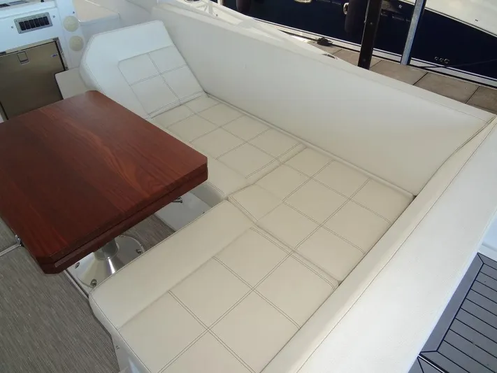  Yacht Photos Pics Luxurious seating area on 2021 Cruisers Yachts 39 Express Coupe with wooden table.