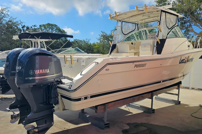 Less Worries Yacht Photos Pics 2004 Pursuit 3070 Express boat with twin Yamaha engines on display.