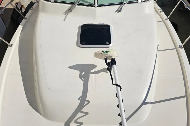 Less Worries Yacht Photos Pics 2004 Pursuit 3070 Express boat deck with mounted equipment and hatch.