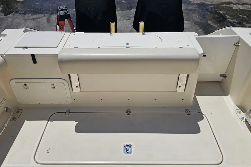 Less Worries Yacht Photos Pics 2004 Pursuit 3070 Express boat deck with storage compartments and seating.