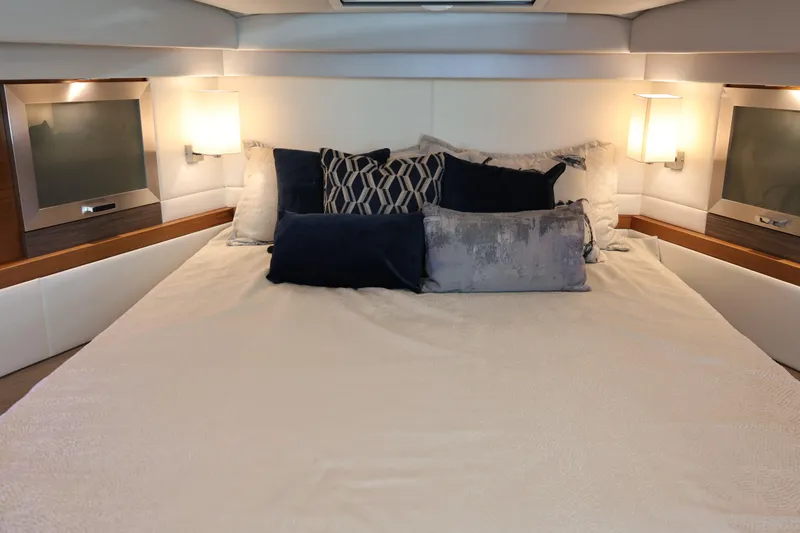 Lady Linn Yacht Photos Pics Luxurious bedroom interior of 2020 Tiara Yachts C44 Coupe with elegant bedding and lighting.