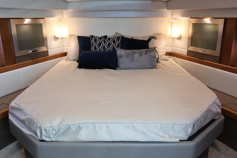 Lady Linn Yacht Photos Pics Luxurious bedroom interior of 2020 Tiara Yachts C44 Coupe with elegant bedding and ambient lighting.
