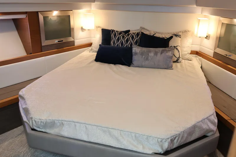 Lady Linn Yacht Photos Pics Luxurious bedroom interior of 2020 Tiara Yachts C44 Coupe with elegant bedding and lighting.