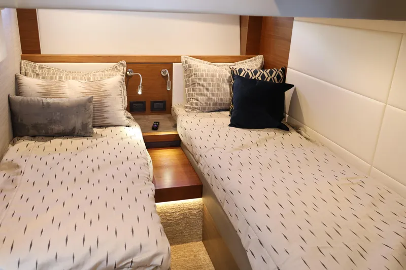 Lady Linn Yacht Photos Pics Luxurious twin cabin interior of 2020 Tiara Yachts C44 Coupe with elegant bedding.
