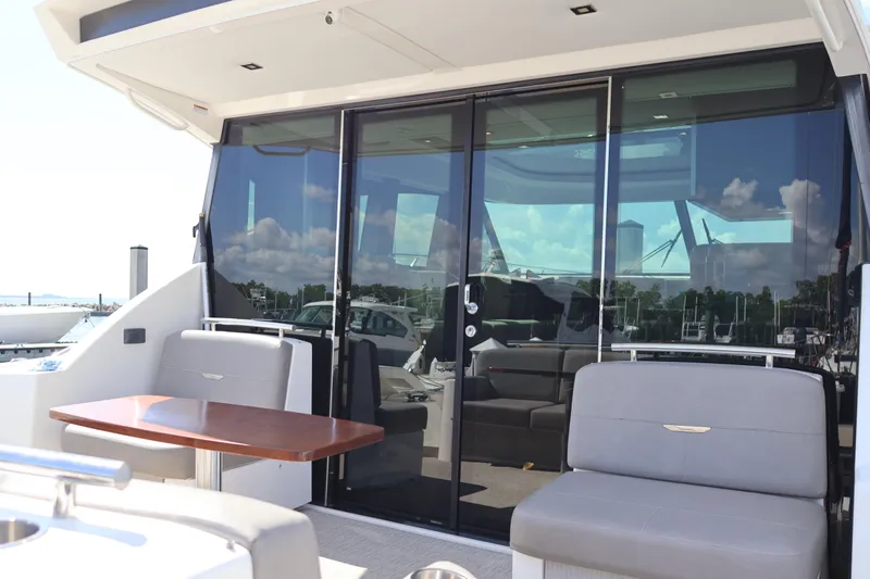 Lady Linn Yacht Photos Pics 2020 Tiara Yachts C44 Coupe with sleek glass doors and comfortable seating area.