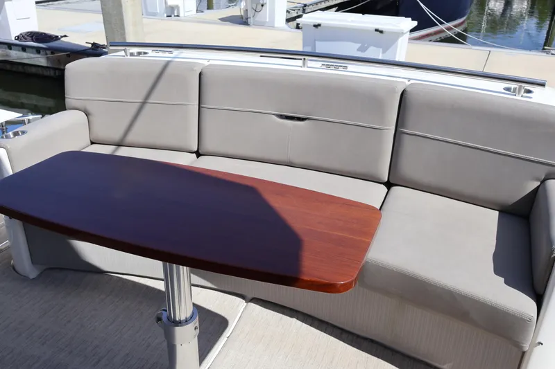 Lady Linn Yacht Photos Pics 2020 Tiara Yachts C44 Coupe interior with gray seating and wooden table.