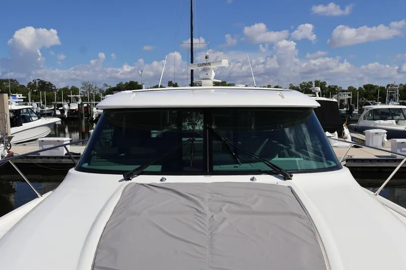 Lady Linn Yacht Photos Pics 2020 Tiara Yachts C44 Coupe docked at marina under blue sky.