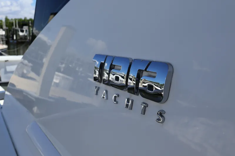 Lady Linn Yacht Photos Pics Tiara Yachts logo on 2020 C44 Coupe, reflecting marina scenery.