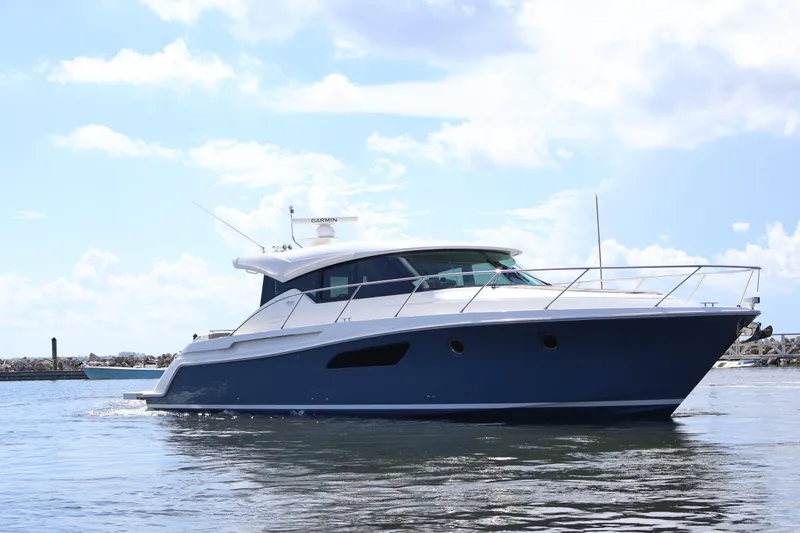 Lady Linn Yacht Photos Pics 2020 Tiara Yachts C44 Coupe cruising on calm waters under a clear sky.