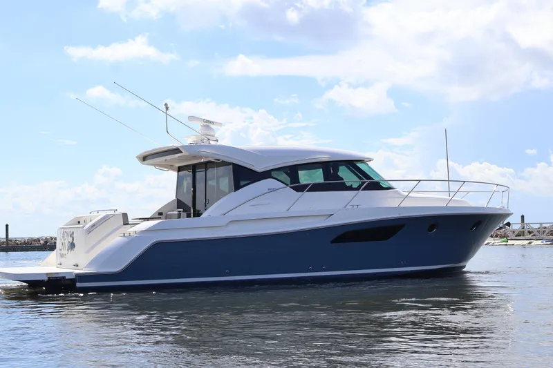 Lady Linn Yacht Photos Pics 2020 Tiara Yachts C44 Coupe on water, sleek design, blue and white exterior.