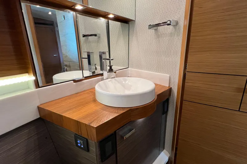 Lady Linn Yacht Photos Pics Luxurious bathroom in 2020 Tiara Yachts C44 Coupe with modern sink and wooden accents.
