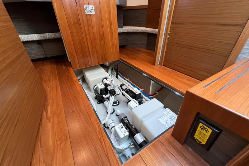 Lady Linn Yacht Photos Pics 2020 Tiara Yachts C44 Coupe interior with open floor panel revealing mechanical components.