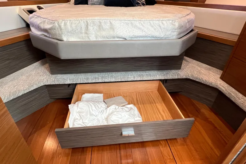 Lady Linn Yacht Photos Pics 2020 Tiara Yachts C44 Coupe interior with bed and open storage drawer.