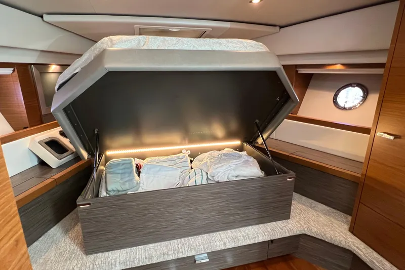 Lady Linn Yacht Photos Pics 2020 Tiara Yachts C44 Coupe interior with under-bed storage open, showcasing modern design.