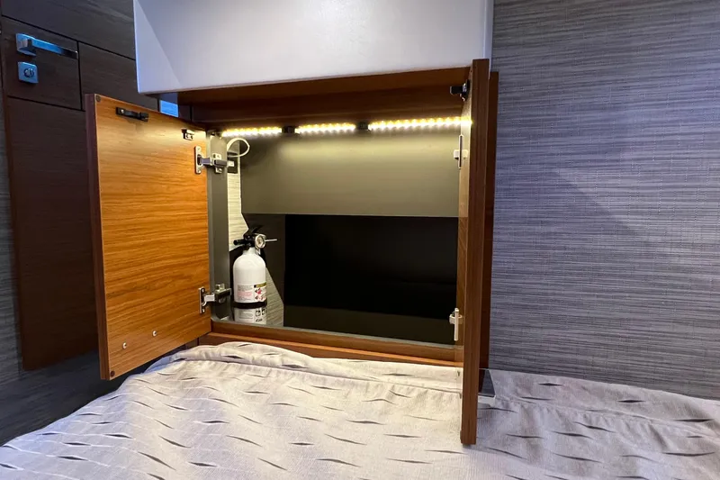 Lady Linn Yacht Photos Pics Open cabinet with fire extinguisher inside Tiara Yachts C44 Coupe, 2020 model.