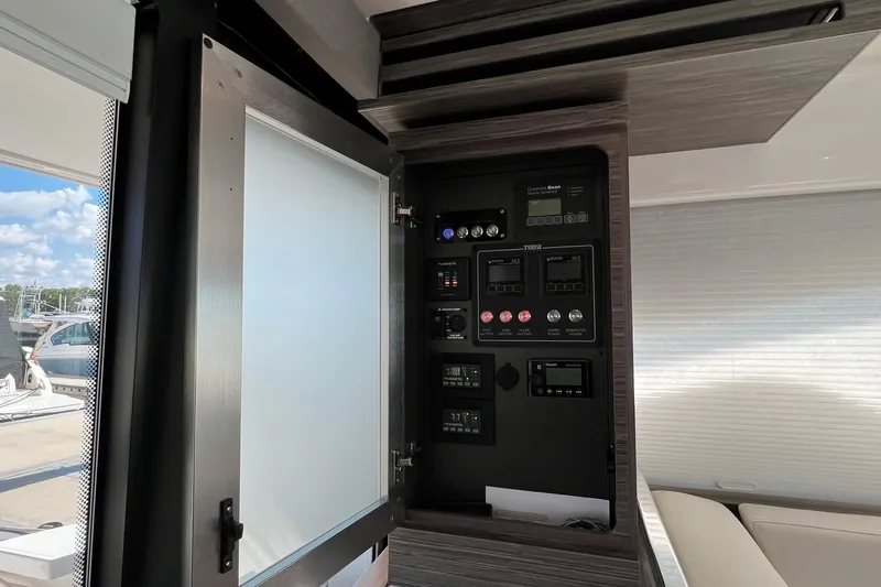 Lady Linn Yacht Photos Pics Control panel inside 2020 Tiara Yachts C44 Coupe, showcasing various switches and displays.